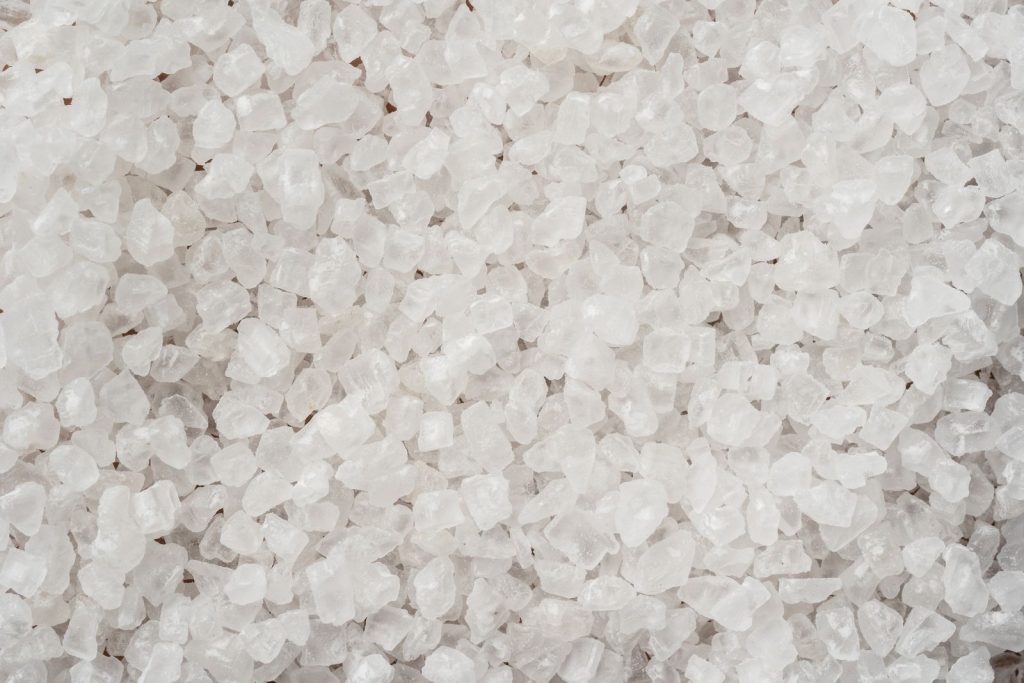 Close-up of coarse white salt crystals filling the frame